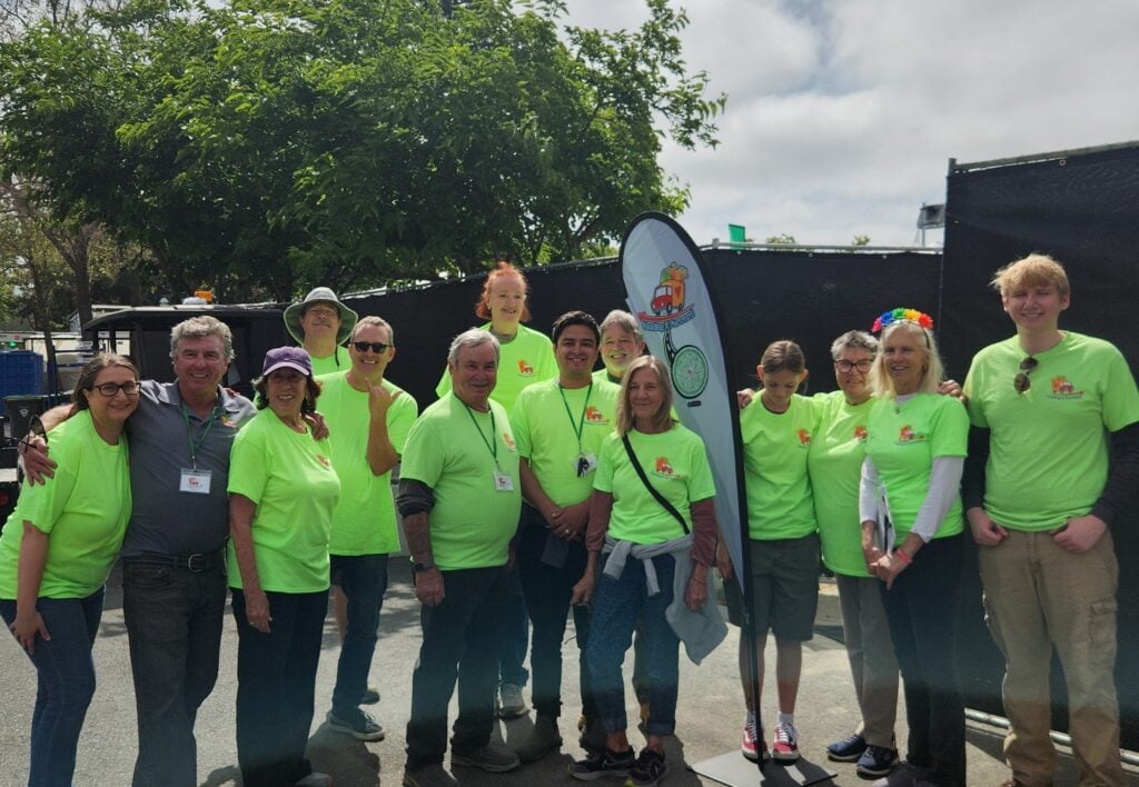 Group wearing green shirts at outdoor event.