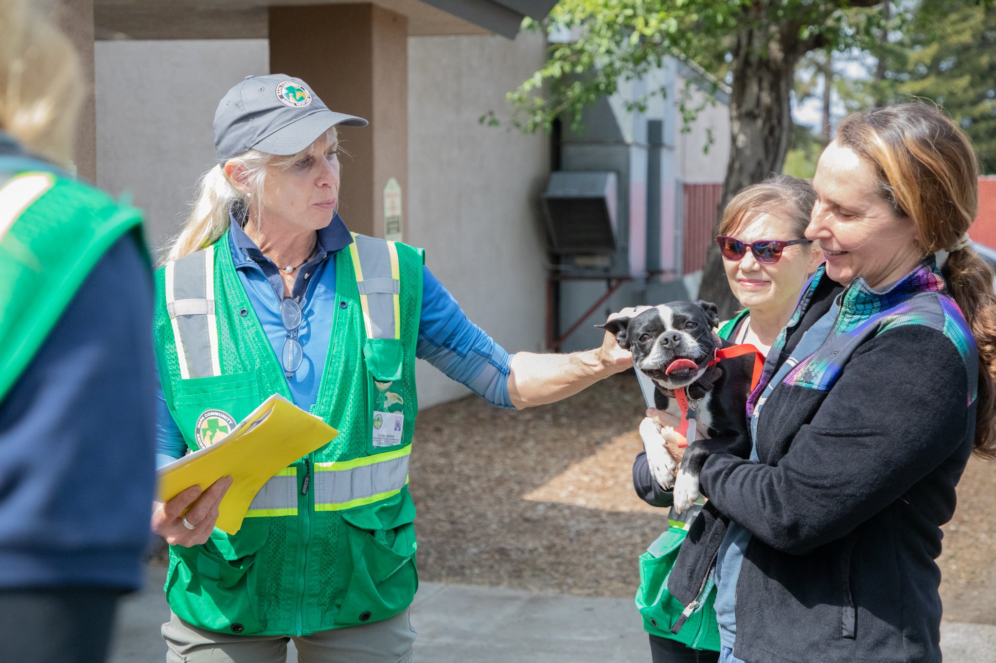 Volunteers caring for a small dog during training.