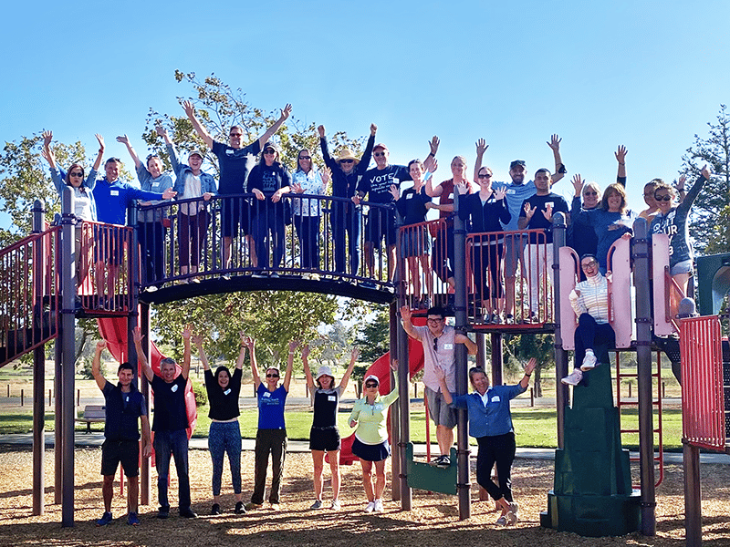 Group of people posing on playground structures.