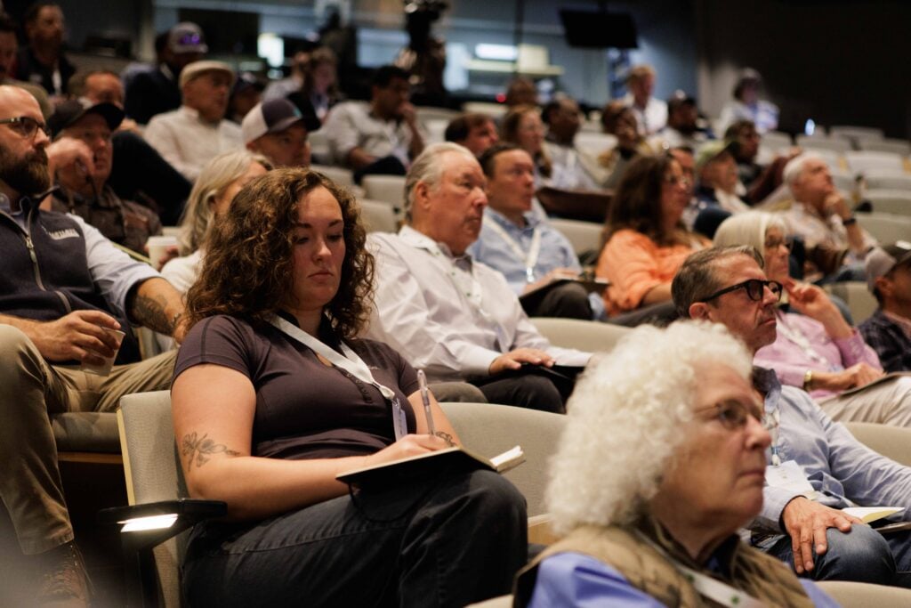 Audience attentively listening at a conference session.